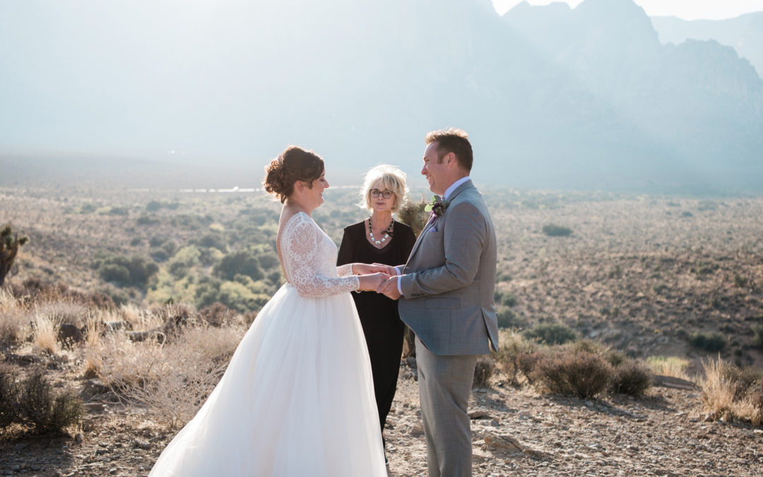 Officiant standing in front of couple at a ceremony.
